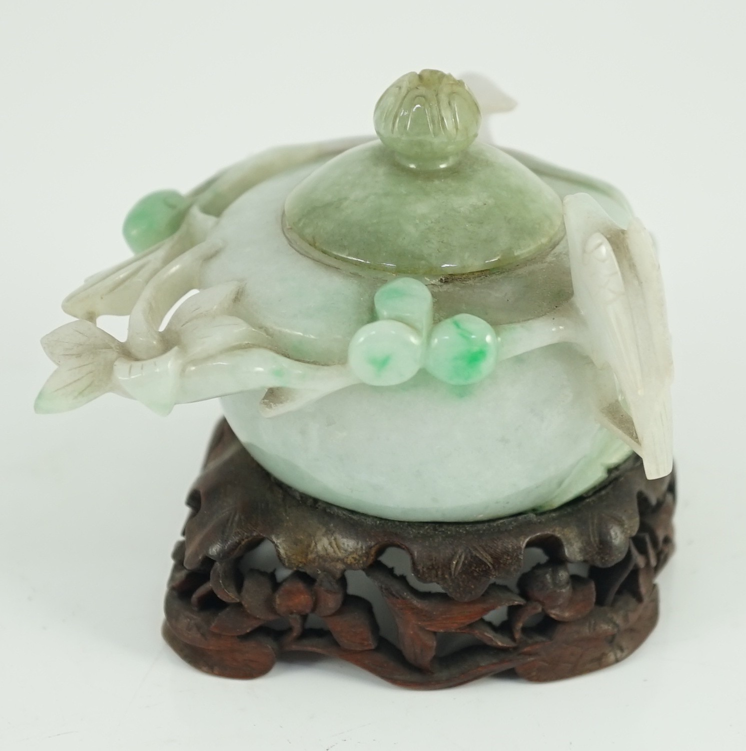 A Chinese lavender and green jadeite water pot and stand, late 19th century, 9.3cm at widest point, wood stand